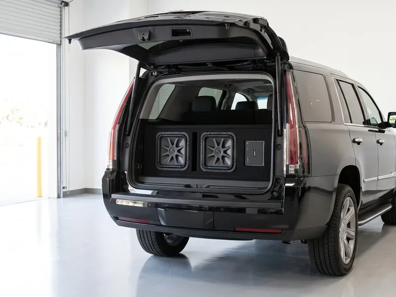 Cadillac Escalade negra con una caja doble de subwoofers Kicker